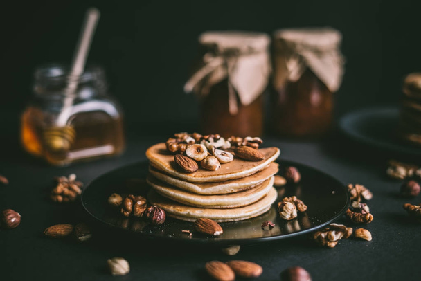 Stack of pancakes with nuts - Фото, изображение