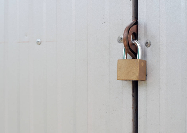 Gold master key locked on the steel gate of the factory, Safety  - Fotografie, Obrázek