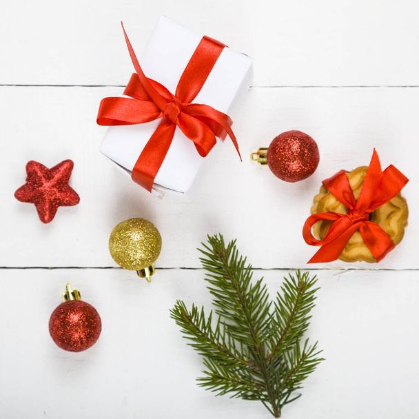 Christmas cookie, spruce branch, gift and balls.   - Fotó, kép