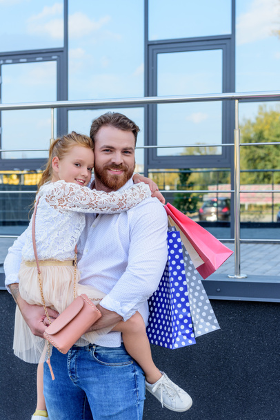 father and daughter with shopping bags - Photo, Image