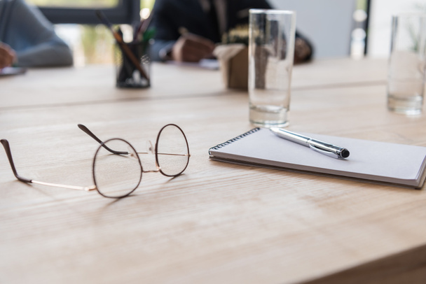 eyeglasses and notebook on table - 写真・画像