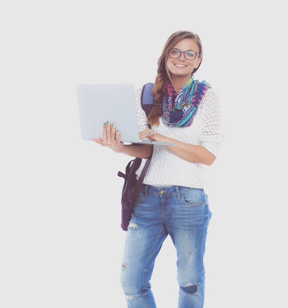 Smiling teenager with laptop on white background - Foto, Imagen