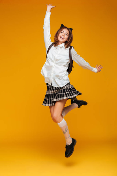 Full length portrait of a young teenage schoolgirl in uniform - 写真・画像