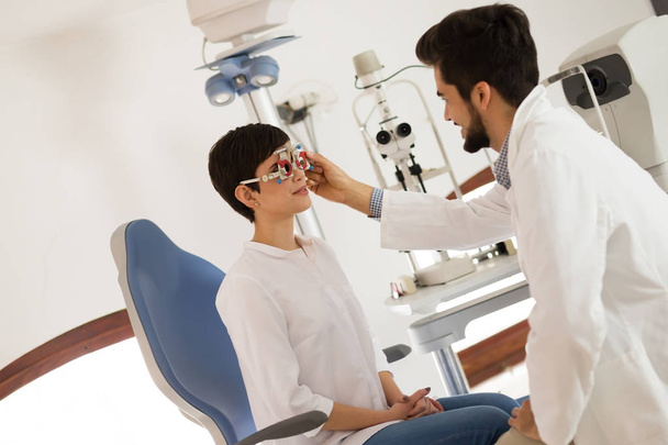 Optometrist examining patient  - 写真・画像