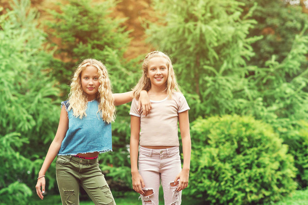 Portrait of beautiful teenager girls twins at park. - Valokuva, kuva