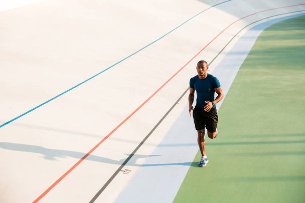 Full length portrait of a fit young sportsman running - Фото, зображення