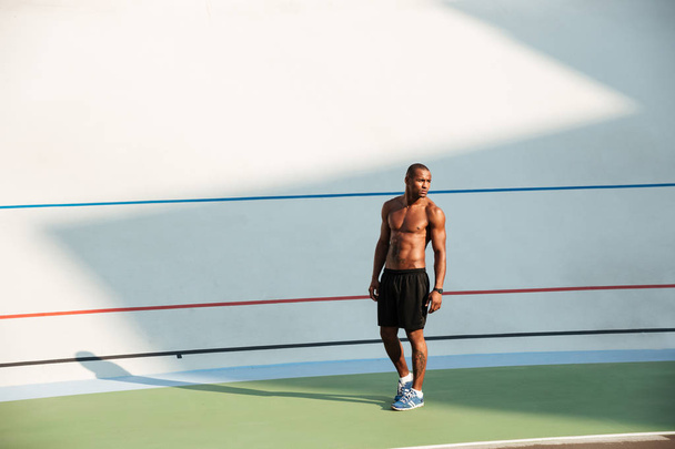 Full length portrait of a fit muscular sportsman standing - 写真・画像