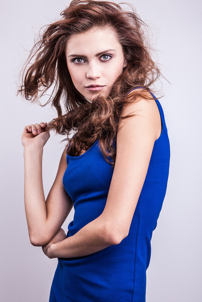 Cute young woman in elegant blue dress - Фото, зображення