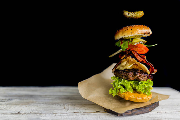 Hamburger with realistic flying ingredients. Tasty smoked grille - Foto, immagini