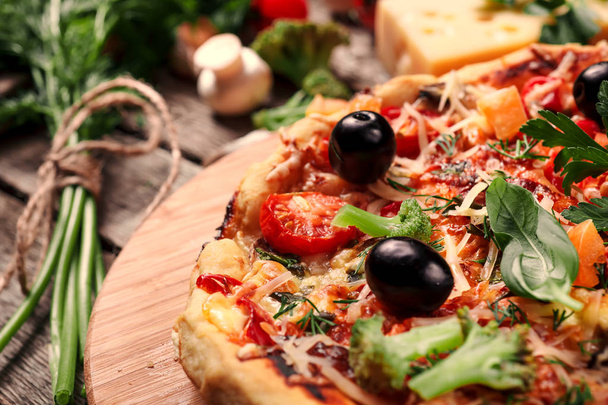Friss pizza paradicsommal, sajttal és gombával a fa asztalon közelkép - Fotó, kép