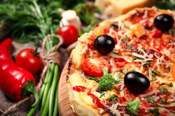 Fresh pizza with tomatoes, cheese and mushrooms on wooden table closeup - Foto, imagen