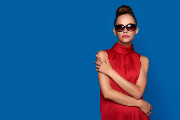 glamour woman in red dress wearing sunglasses - Photo, image