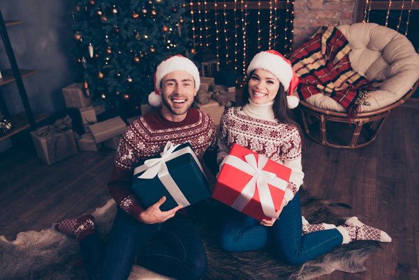 Festive husband and wife are receiving gifts with white ribbon b - Foto, Bild