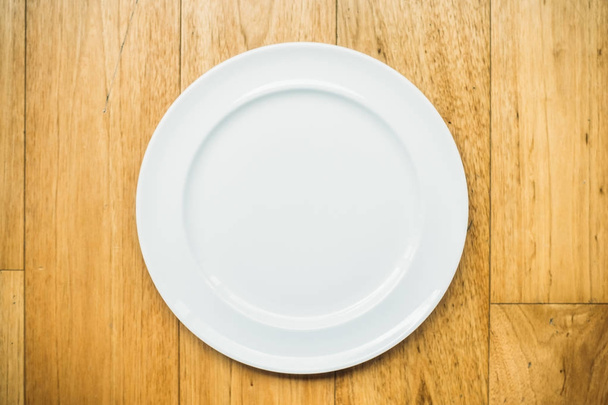 Empty white plate on wooden background - Photo, Image