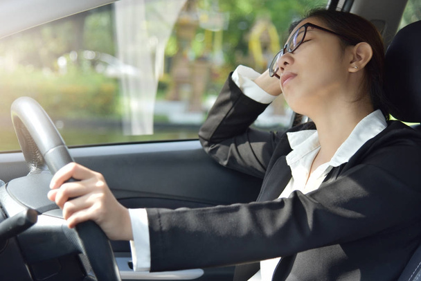 Business woman sleeping while driving a car. - Valokuva, kuva
