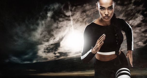A strong athletic, female sprinter, running at sunrise wearing in the sportswear, fitness and sport motivation concept with copy space. - Фото, зображення