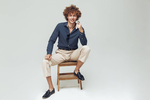 Positive retro man dressed in shirt sitting and posing - Foto, immagini