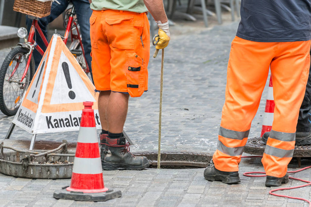 Street works on sewer channel  with warn sign in german words for channel works - Photo, Image