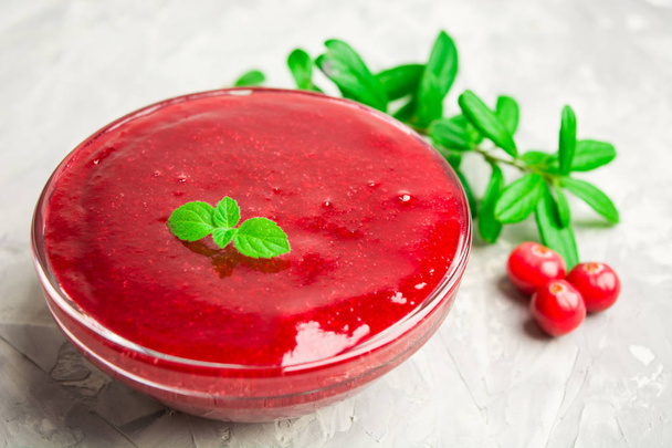 Cranberry sauce in glass jar with selective focus - Φωτογραφία, εικόνα