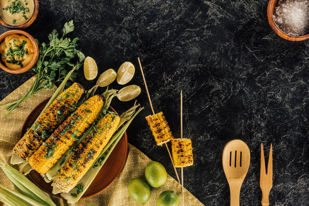 grilled corncobs with wooden spatulas - Photo, Image