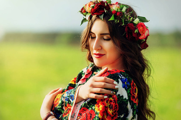 Beautiful woman in colorful ukrainian traditional dress holding  - Photo, Image