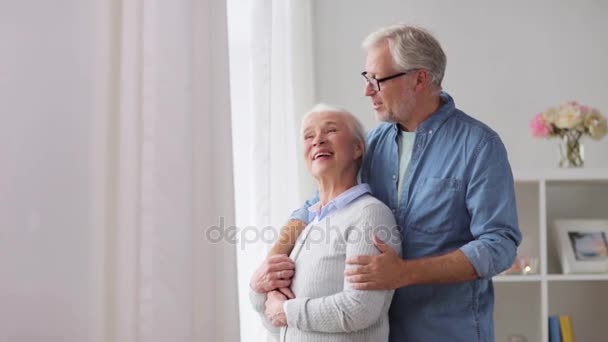 happy senior couple looking through window at home - 映像、動画