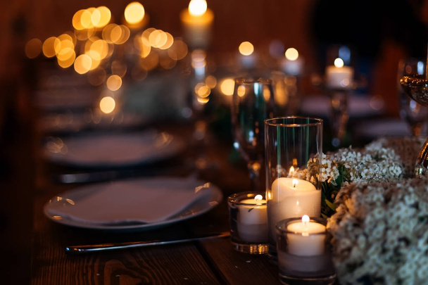 Candles on wedding table set on a beautiful lit background. Forg - Фото, зображення