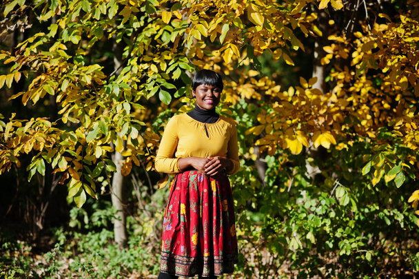 African american girl at yellow and red dress at autumn fall par - Foto, Bild