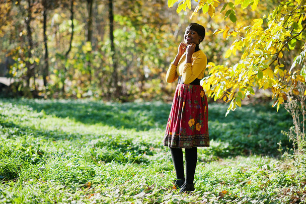 African american girl at yellow and red dress at autumn fall par - Фото, изображение