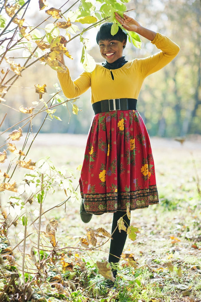 African american girl at yellow and red dress at autumn fall par - Foto, Imagem