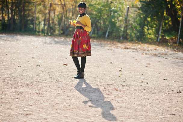 African american girl at yellow and red dress at golden autumn f - Photo, Image