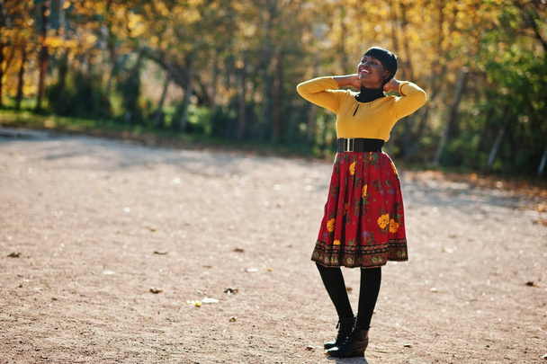 African american girl at yellow and red dress at golden autumn f - Zdjęcie, obraz
