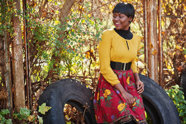 African american girl at yellow and red dress at golden autumn f - Фото, зображення