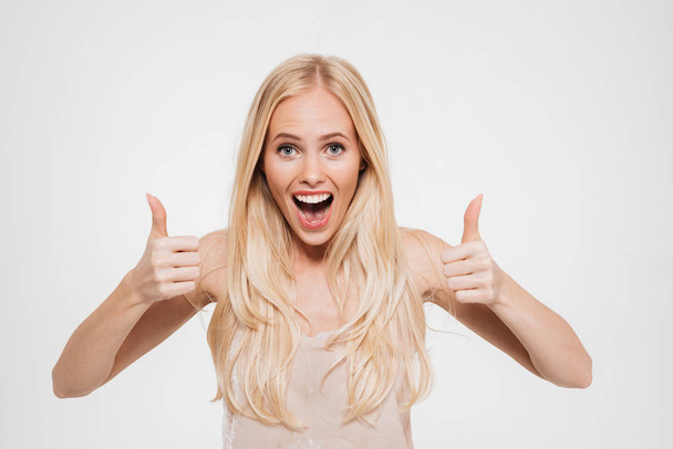 Portrait of a happy excited woman showing thumbs up - Fotografie, Obrázek