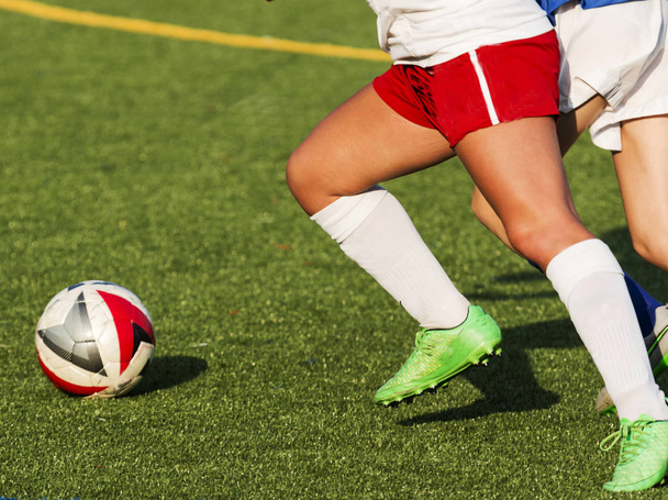 Two female high school soccer players chasing the ball - Photo, Image