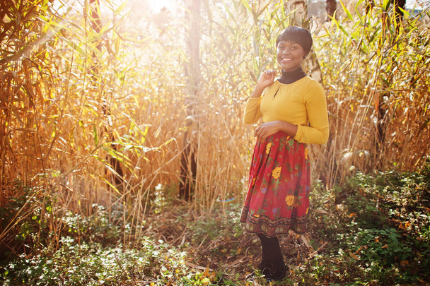 African american girl at yellow and red dress at golden autumn f - Фото, изображение