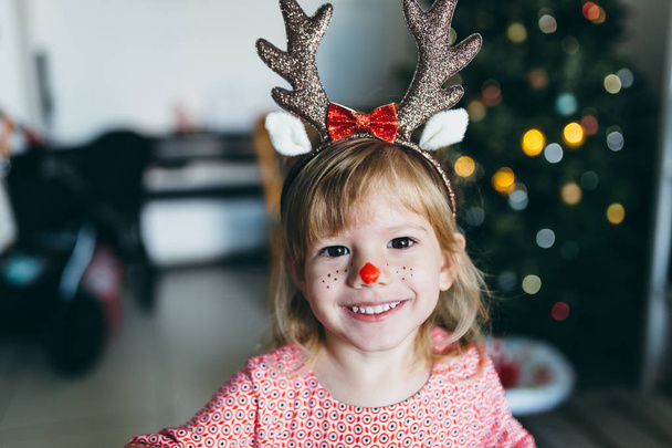 girl in funny Christmas antlers - Fotó, kép