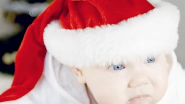 Baby in Christmas hat on the new year background - Materiał filmowy, wideo