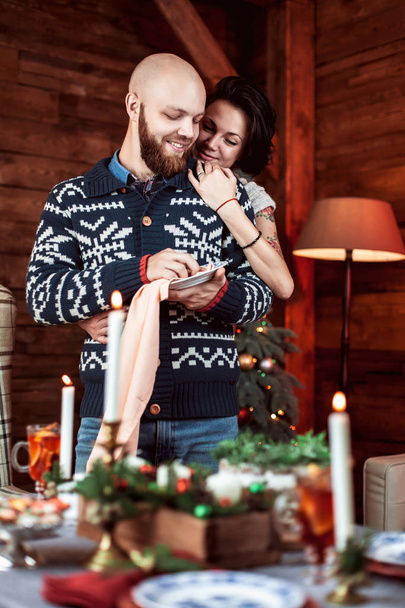 Beautiful couple with a Christmas tree. - Фото, зображення