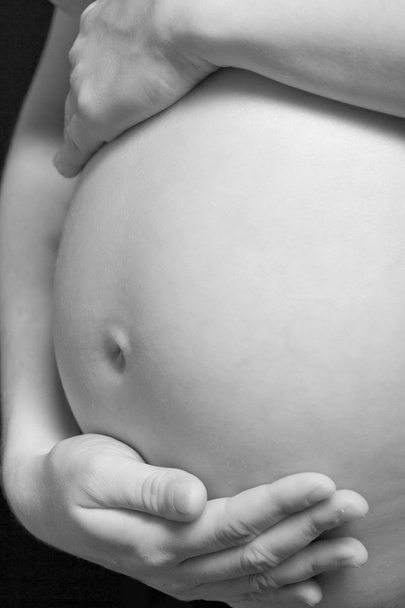 Nahaufnahme einer schwangeren Frau in Schwarz-Weiß - Foto, Bild