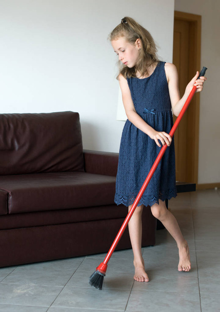 Little girl is cleaning the apartment. - Photo, Image