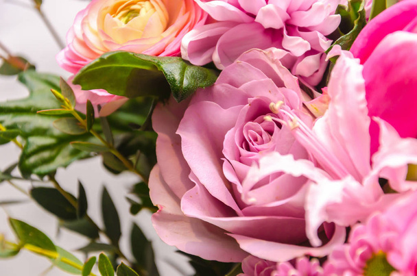 Delicate fresh bouquet of fresh flowers with a pink rose.  - Photo, Image