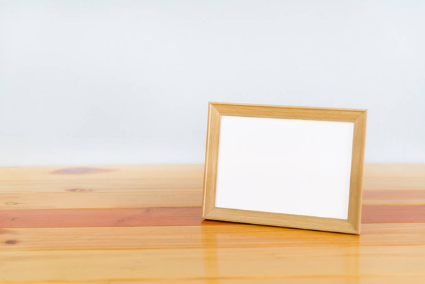 Empty wood photo frame on wooden table with copy space, picture  - Foto, imagen