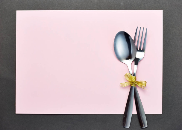 silver spoon and white napkin on pink with gray background - Φωτογραφία, εικόνα
