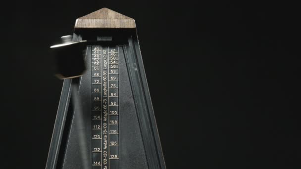 Close-up shot of vintage metronome with golden pendulum - Footage, Video