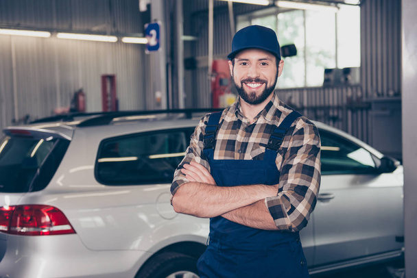 Attractive successful caucasian car expert at work shop standing - Фото, изображение