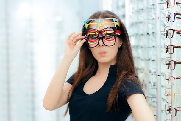 Funny Woman Trying Many Eyeglasses Frames in Optical Store - Fotoğraf, Görsel
