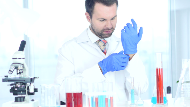 Scientist, Doctor Wearing Gloves in Hands Before Starting Work - Кадри, відео
