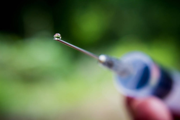 Syringe with needle on blur background - Photo, Image