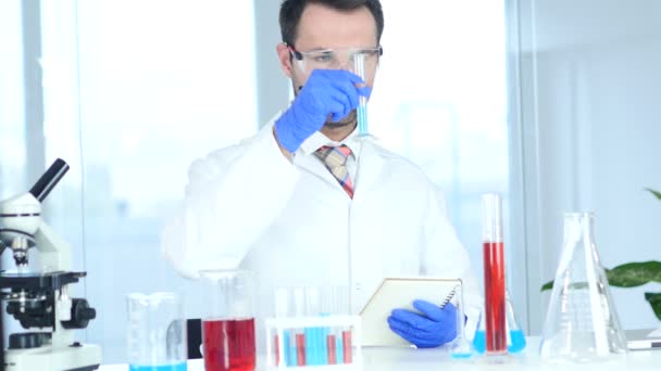 Scientist Writing Details, Result of Research in Laboratory - Materiał filmowy, wideo